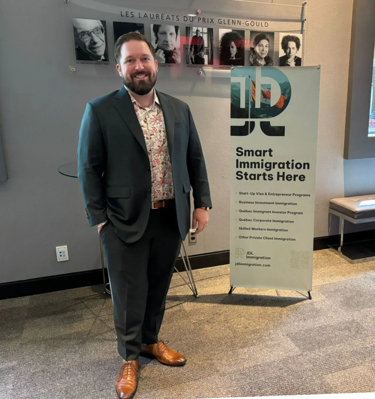 David Comtois next to the JDL Immigration banner at Toronto Tech Week